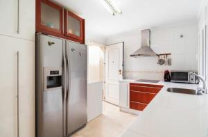 a kitchen with a stainless steel refrigerator at Chalet en la Barrosa in Novo Sancti Petri