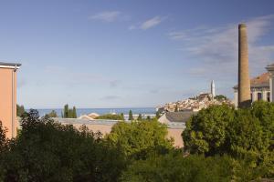 a view of a city with two smoke stacks at Art Apartment in Rovinj