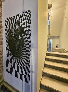 a painting of a man on a wall in a hallway at Bill Apartments in Patra