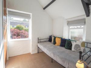 a couch in a room with a window at Maes y Derw Coach House Newcastle Emlyn in Newcastle Emlyn