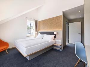 Postel nebo postele na pokoji v ubytování Das Neue CAPITOL + 14 fotografií