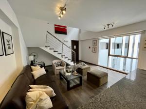 a living room with a couch and a table at Elegant 1Bed Duplex in Lima