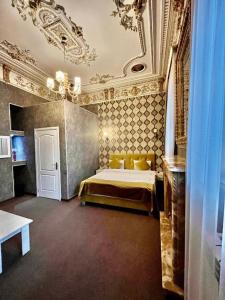 a bedroom with a bed and a ceiling at Nizami Boutique Hotel in Baku