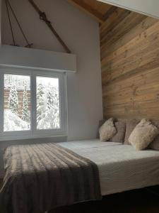 een slaapkamer met een bed en een raam bij Appartement à deux pas du centre de Crans-Montana in Crans-Montana