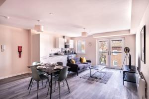 a living room with a table and a couch at Modern & Stylish 2 Bed Apartment in Manchester in Manchester