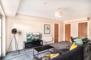 a living room with a couch and a table at Modern & Stylish 2 Bed Apartment in Manchester in Manchester