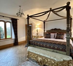 a bedroom with a canopy bed and a chandelier at Claregalway Castle in Claregalway