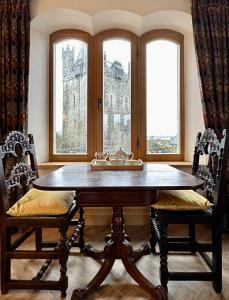 a dining room with a table and two chairs at Claregalway Castle in Claregalway