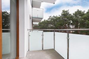 a balcony with white doors and a window at Mieszkanie blisko Zawiszy in Bydgoszcz