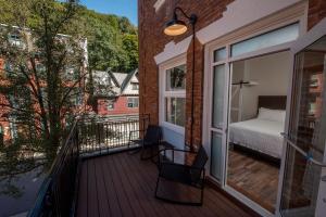 a balcony with a bedroom and a bed on it at The Y On Broadway in Jim Thorpe