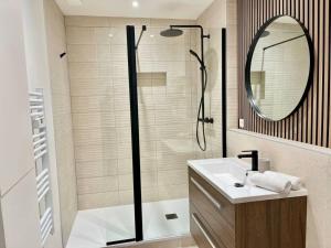 a bathroom with a shower and a sink and a mirror at Floréa Reims avec du charme proche gare et centre in Reims