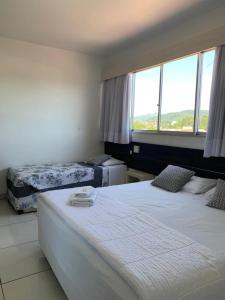 Postel nebo postele na pokoji v ubytování Hotel Comoditá Ltda