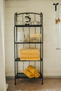 a black shelf with towels on it in a room at Metsatuule puhkeküla in Hiiumaa +53 photos