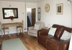 a living room with a couch and a chair at Dinmore in Richmond +2 photos