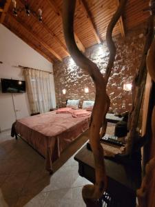 um quarto com uma cama numa parede de pedra em Grandpa's home em Areopoli
