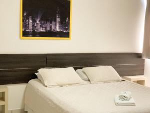 Postel nebo postele na pokoji v ubytování Hotel Comoditá Ltda