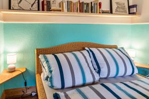 a bedroom with a bed with a blue wall at Bücherträume in Windeby