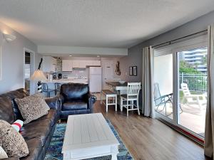 a living room with a couch and a table at Aqua Villa #101 in Fort Walton Beach