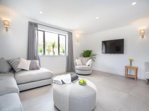 a living room with a couch and a table at Deer View in Ottery Saint Mary