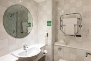 a white bathroom with a sink and a mirror at Holiday Inn Brentwood by IHG in Brentwood +136 photos