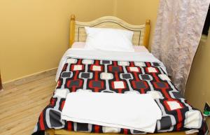 two beds in a room with a bedskirts at Banana Hills Haven in Narok