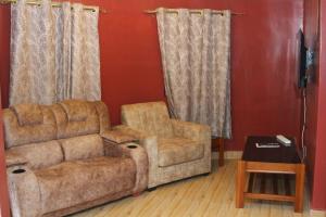 a living room with a couch and a chair at Banana Hills Haven in Narok