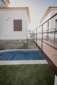 a pool in the backyard of a house at Residencial Neade Suites in Sanlúcar de Guadiana