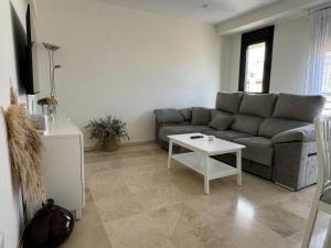 a living room with a couch and a table at Apartamento céntrico con terraza in Córdoba