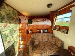 a small bedroom with a bed and a ladder in a room at The Skewbald in Letterbreen
