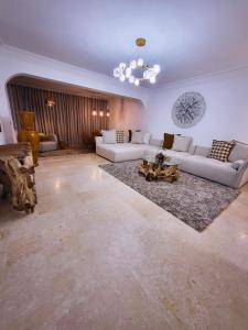 a large living room with couches and a table at Appartement Oxygène Marrakech Sun in Marrakesh