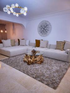 a living room with two couches and a coffee table at Appartement Oxygène Marrakech Sun in Marrakesh