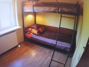 a room with two bunk beds and a couch at Willa Mister J. in Dziwnów
