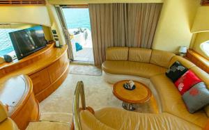 a living room with a couch and a tv at Vision yatch in Göcek