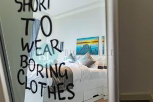 um quarto com uma cama com escrita no espelho em Stylish Studio In Pixel em Abu Dhabi