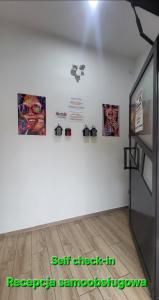 a white room with some pictures on the wall at Apartamenty Premium PRETTY WOMAN self check-in 24h - Bytom Chorzów Katowice in Bytom