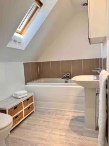 a bathroom with a white tub and a sink at Wonderful Beach House Just 250m From The Sea in Newquay