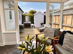 a screened in porch with a couch and a table at Wonderful Beach House Just 250m From The Sea in Newquay