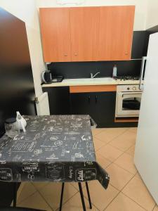 a small kitchen with a table and a stove at Hostel Lisięcice in Lisiecice