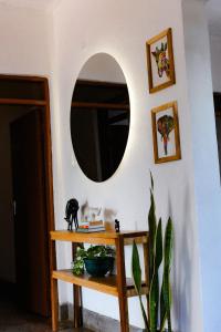 a room with a mirror and a table with a plant at Goodtimewithfar House in Moshi