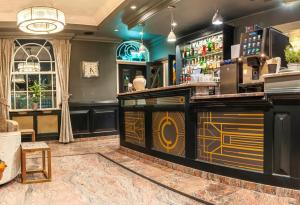 a bar in a restaurant with a bar counter at The California - London Kings Cross in London