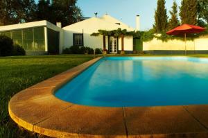 a swimming pool in front of a house at Quinta Nova do Archino 18 in Alenquer