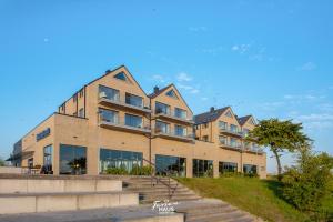 a building on a hill with a blue sky at ROOFTOP Garden ACHT in Olpenitz