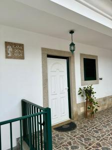 een witte deur in een witte muur met een trap bij A Casa Dos Avós in Penha Garcia