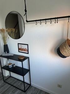 a room with a table and a mirror on the wall at Ferienwohnung Idylle auf Fehmarn I in Vitzdorf