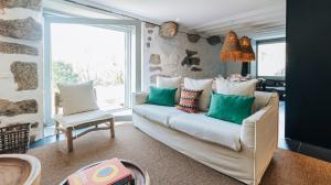 a living room with a couch and two chairs at Casa da Cascata in Geres +23 photos