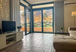 a living room with a television and a view of the ocean at Paz Ocean View, Air condition, Wifi, Heated pool in San Miguel de Abona