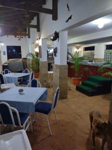 a restaurant with tables and a dog standing in the room at Florances Rest House in Nairobi