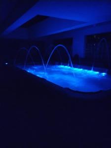 a swimming pool with blue lights in a dark room at Florances Rest House in Nairobi