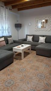 a living room with a couch and a table at Casa preciosa con vistas in Granada