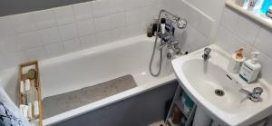 a bathroom with a white tub and a sink at 1 Bedroom Flat 27 Mins to London Victoria in Sydenham